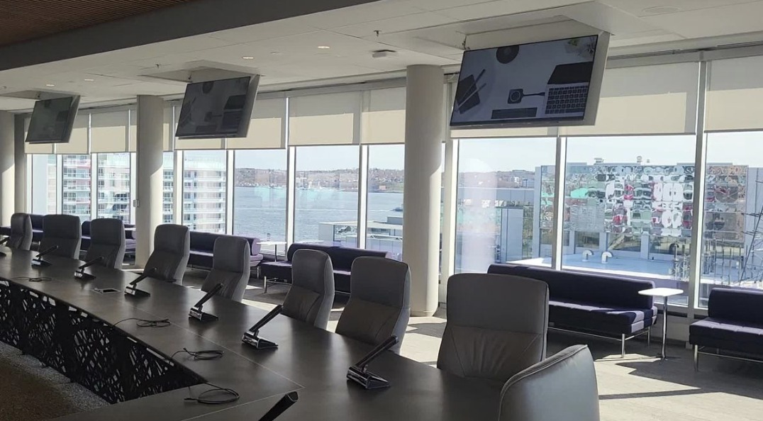 Boardroom with delegate microphones and ceiling-mounted displays, AudioVisual system by Backman Vidcom
